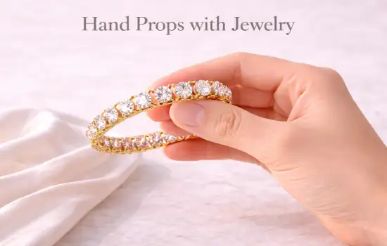 hand prop for jewelry photography showing gold bangle held close for size and detail